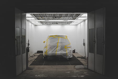 covered white vehicle on black mat thumbnail