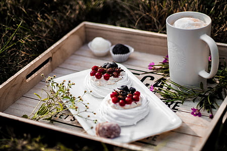 cookies covered with white icing served on white platter in brown wooden tray thumbnail
