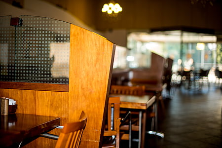 selective focus photography of brown wooden table near wall thumbnail