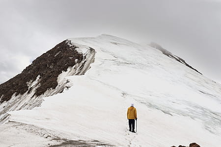 Man Climbing Snow Covered Hill thumbnail
