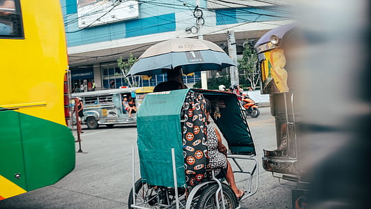 white tricycle with riders thumbnail