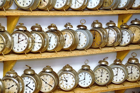 gray alarm clock lot on brown wooden shelf thumbnail