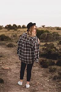 woman standing near bushes thumbnail