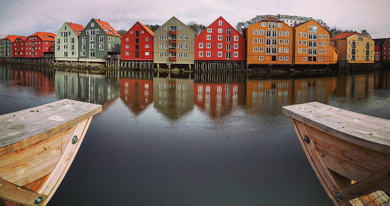 assorted color houses near body of water during daytime thumbnail