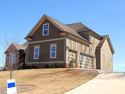 gray and brown house under blue sky during daytime thumbnail