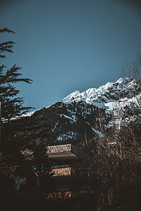 low-angle photography of building on snow-covered mountain slope thumbnail