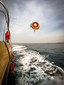 person doing parasailing during daytime thumbnail