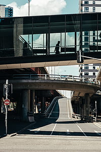 silhouette photo of person walking on bridge during daytime thumbnail