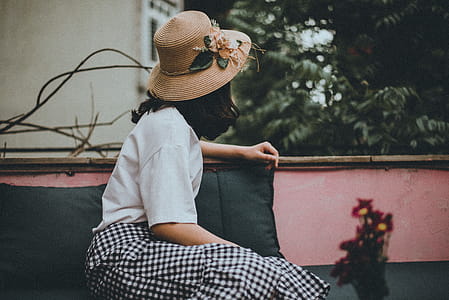 Woman Wearing Sun Hat Looking Backward thumbnail