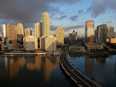bridge connecting a city under cloudy sky thumbnail