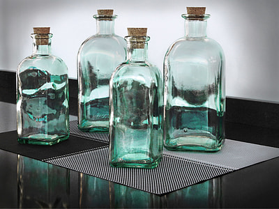 four clear glass bottles on grau marble countertop thumbnail