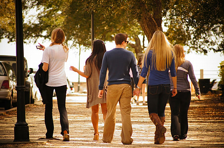 five people walking near street during daytime thumbnail