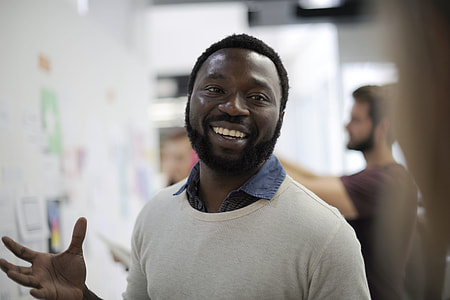 man wearing white beige boat-neck shirt smiling thumbnail