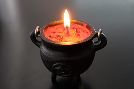 red candle in black candle holder thumbnail