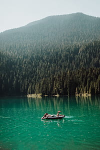 two person lying on inflatable float across mountain thumbnail