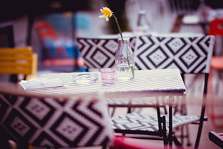 yellow flower in clear glass vase on the table thumbnail