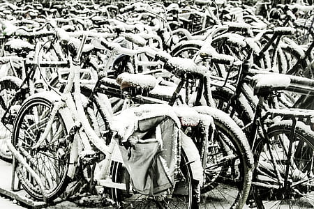 grayscale photography of bicycles covered with snow thumbnail