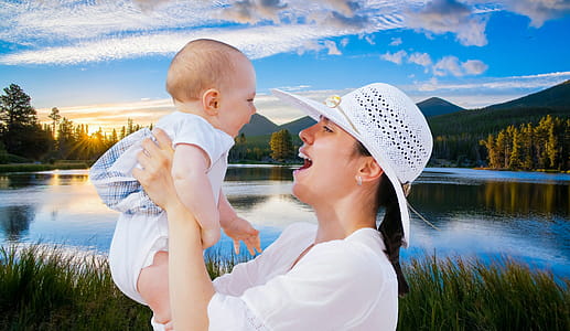 Photo illustration of happy mother with baby against lake background thumbnail
