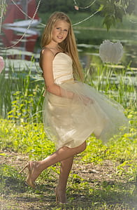 girl in white sweetheart neckline strapless dress on green grass field thumbnail