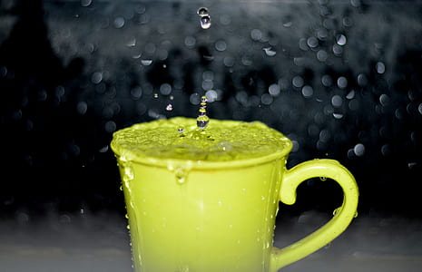 Yellow Ceramic Mug With Water Droplets in Time Lapse Photography thumbnail