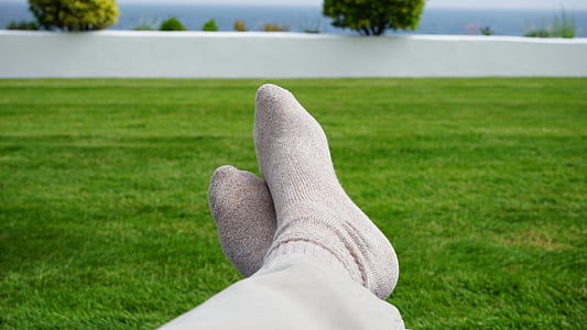 person sitting on green grass at daytime thumbnail