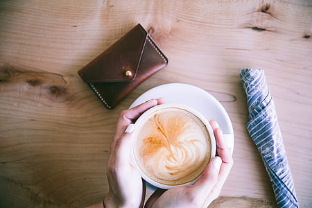 person holding cup of coffee thumbnail