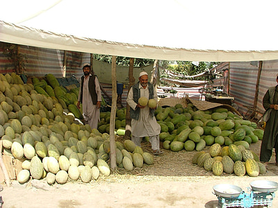 man holding two watermelons thumbnail