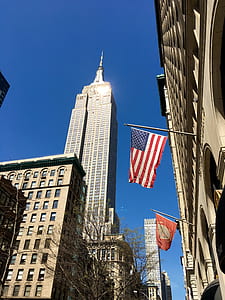 USA flag hanging on concrete building thumbnail