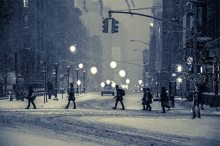 people walking on snow covered street during daytime thumbnail