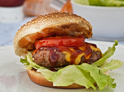 selective focus photography of hamburger filled with ham, cabbage and sliced tomato thumbnail