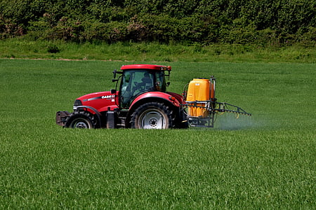 red tractor on green field thumbnail