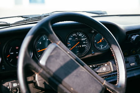 Side view of interior of a car with speedometer, dashborad and windshield in the background thumbnail