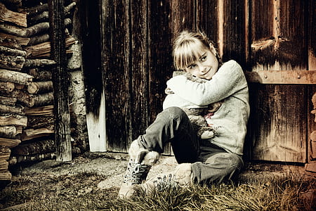woman seating behind brown wooden wall thumbnail