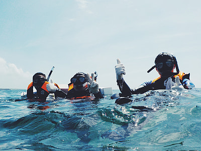 three person on body of water thumbnail