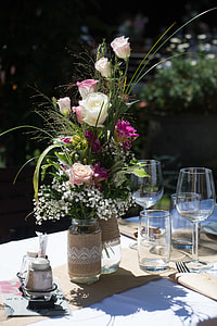 white and pink flowers bouquet beside wine glasses thumbnail