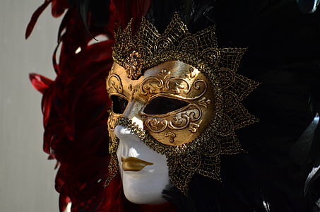 shallow focus photography of gold, black, and red masquerade mask thumbnail