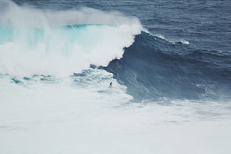 time lapse photography of man surfing on water thumbnail