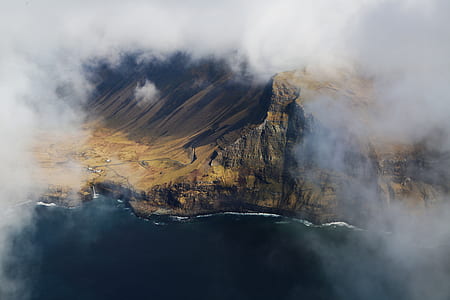 aerial photo of mountain near ocean thumbnail
