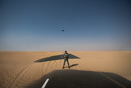 Man Standing in the Middle of Desert Place thumbnail