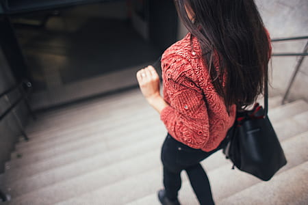 woman in red top walking down on stair thumbnail
