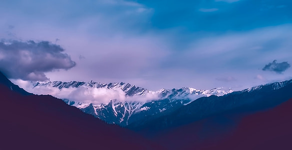 snow capped mountain under gray clouds thumbnail