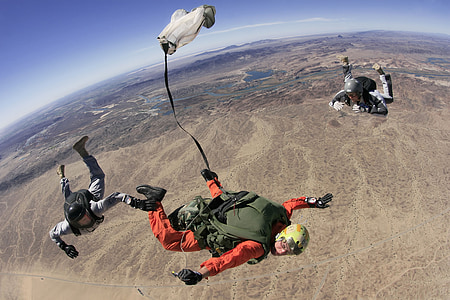 three person floating on sky at daytime thumbnail