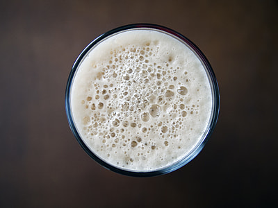 clear drinking glass filled with white liquid thumbnail