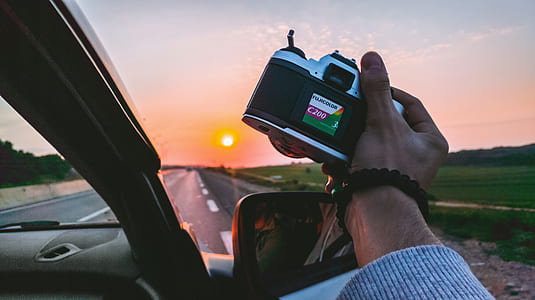 person holding DSLR camera thumbnail
