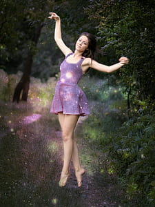 woman dancing near trees thumbnail