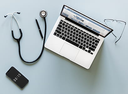 silver MacBook beside stethoscope and pen thumbnail