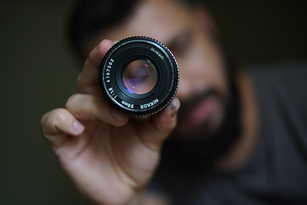 Photographer holding camera lens thumbnail
