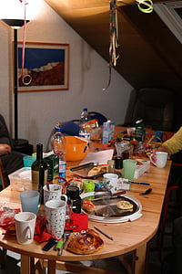 oblong brown wooden table filled with assorted items thumbnail