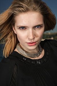 portrait photography of woman in black crew-neck top thumbnail