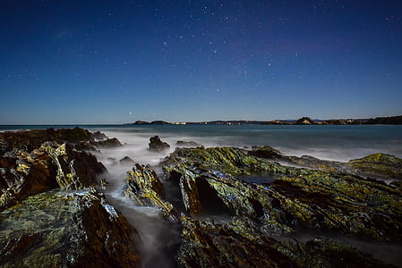 body of water and rock formations thumbnail